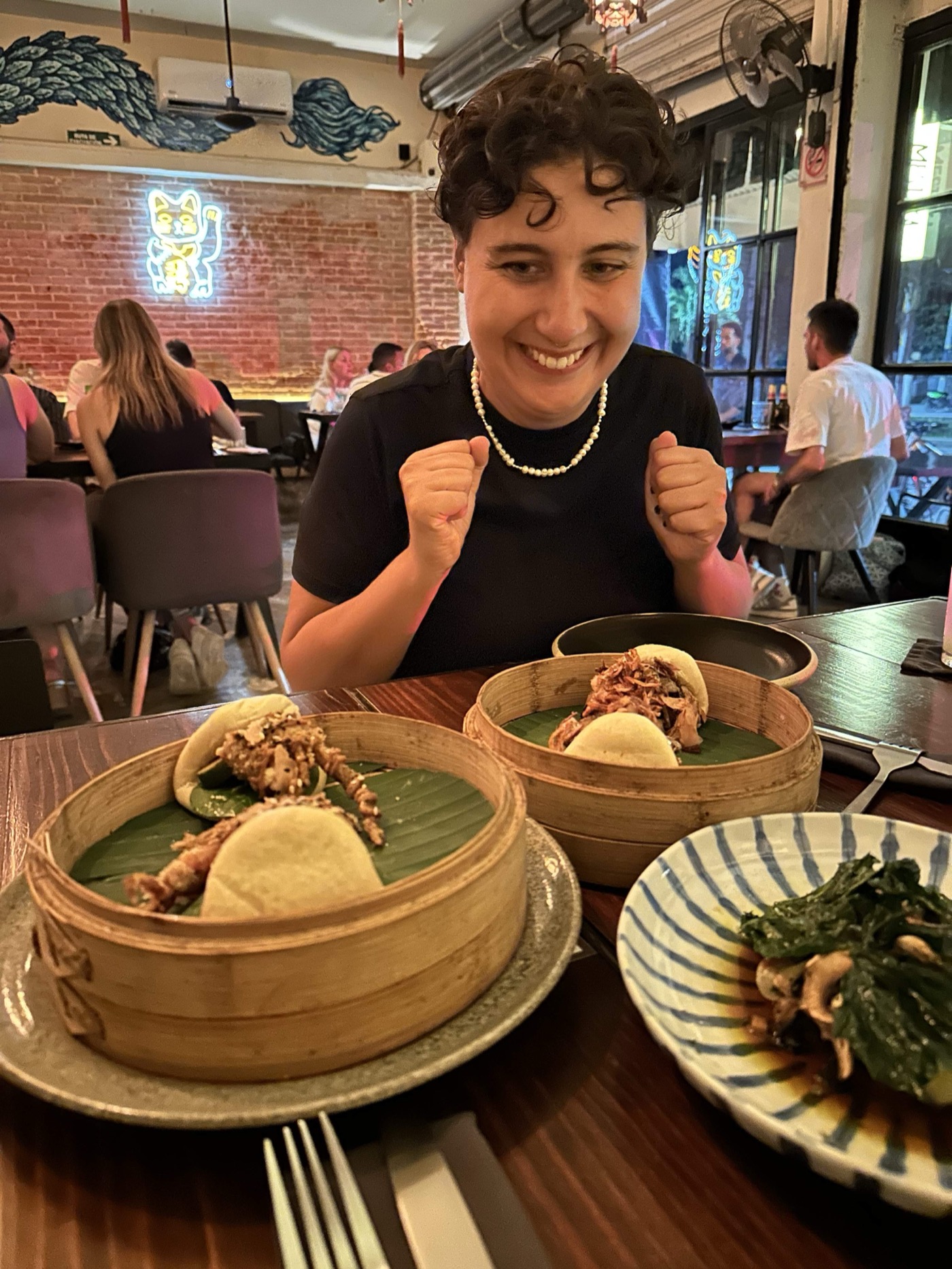 Guest excited over a bao spread at a sit-down Tulum restaurant