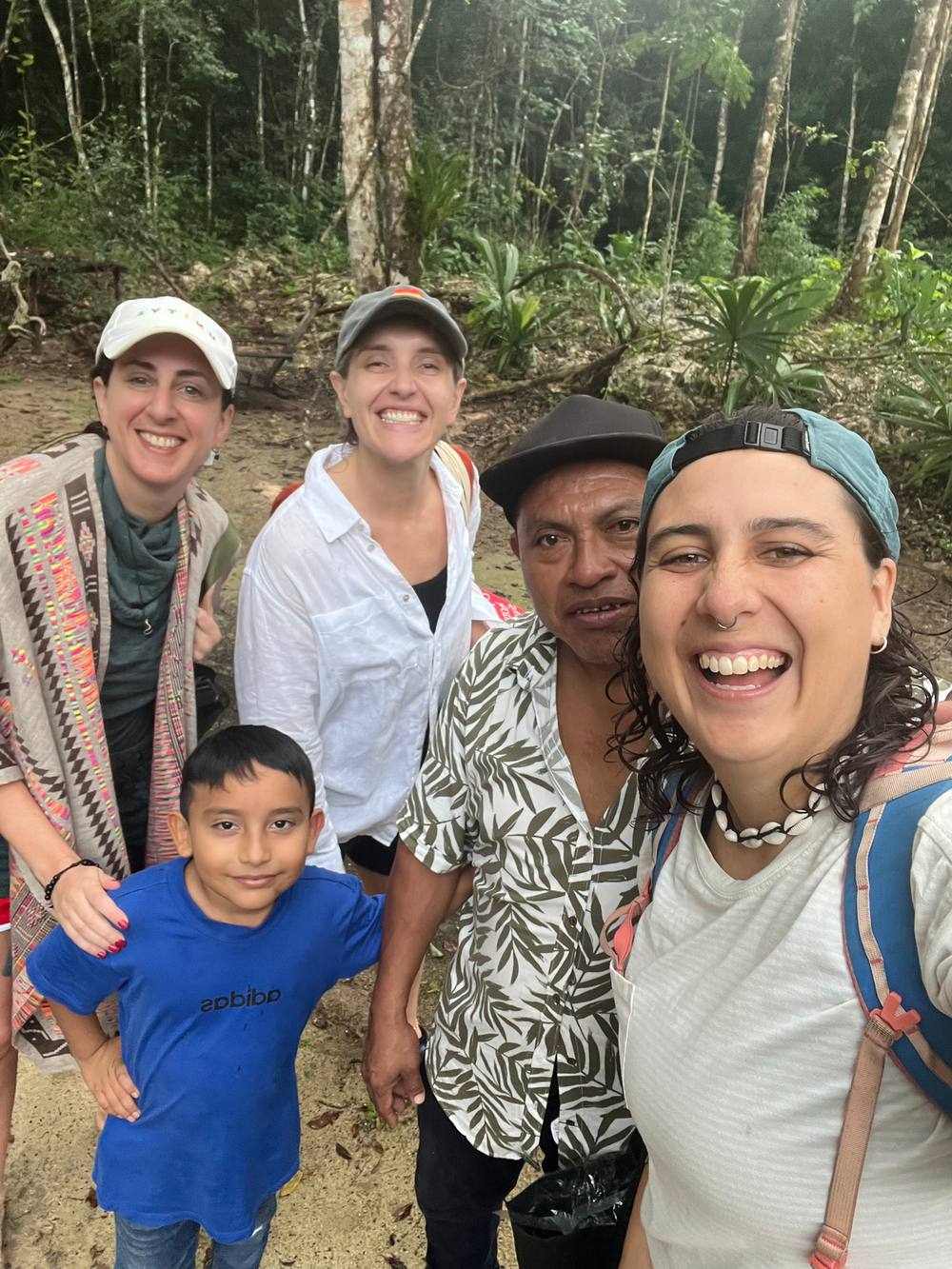 Guide laughing with a group and a local Mayan guide and his son in the jungle near Tulum