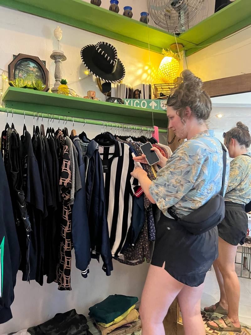 Guests browsing a curated storefront shop in Tulum town at dusk