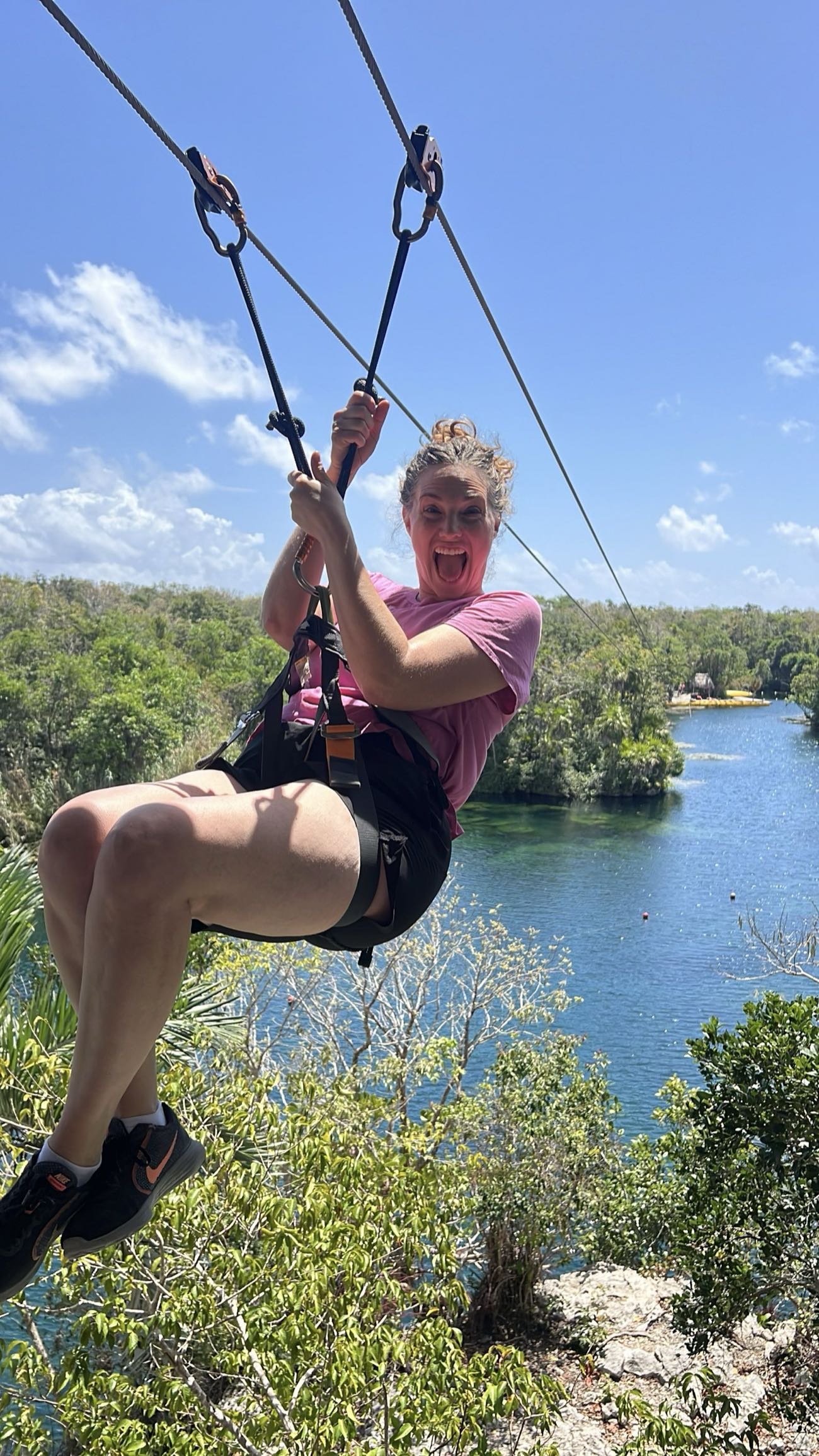 Guest ziplining above the lagoon at Tankah near Tulum