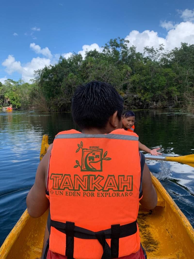 Guests canoeing through jungle canals at Tankah, wearing life vests